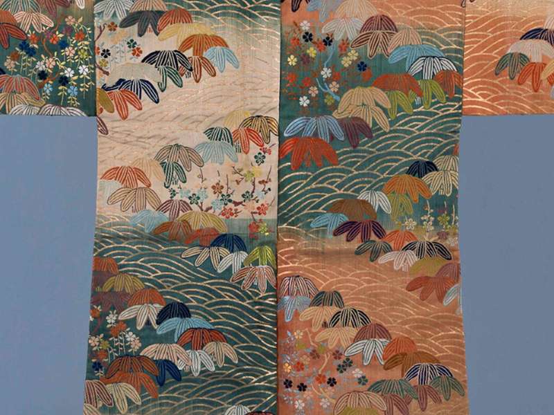Karaori, Design of abstract wave pattern (seigaiha), Bamboo grass, plum blossoms and cherry blossoms on a ground of alternating blocks of orange-red, white and green, Edo period, 18th century | Courtesy &copy; Sen-Oku Hakukokan Muse