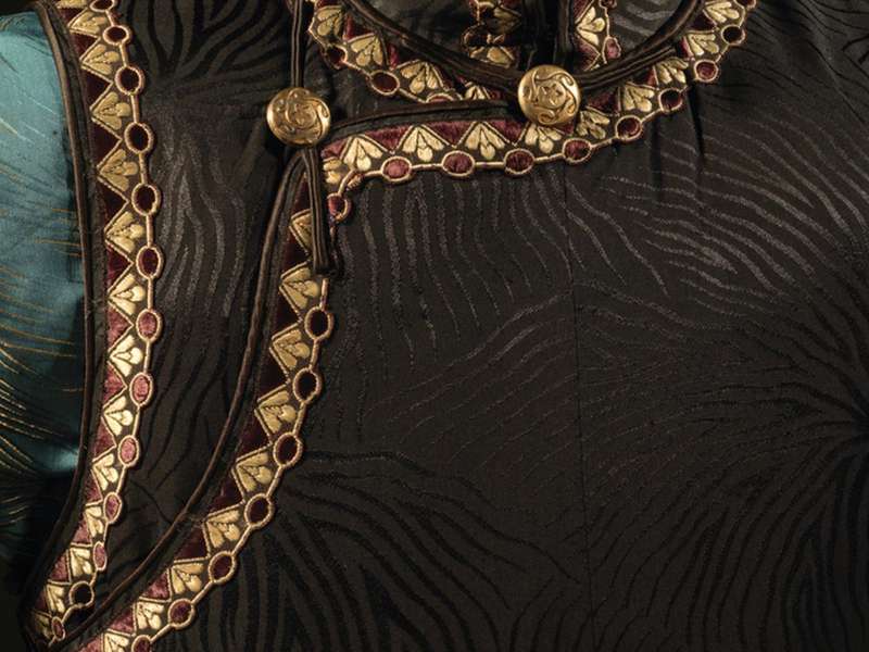 Qipao: Glamour and Modernity beyond Shanghai, Aquamarine Bell-Sleeved Jacquard Silk Blouse with Beige Veining Pattern / Black Damask Silk Long Vest with Veining Pattern | Courtesy The Shanghai Museum