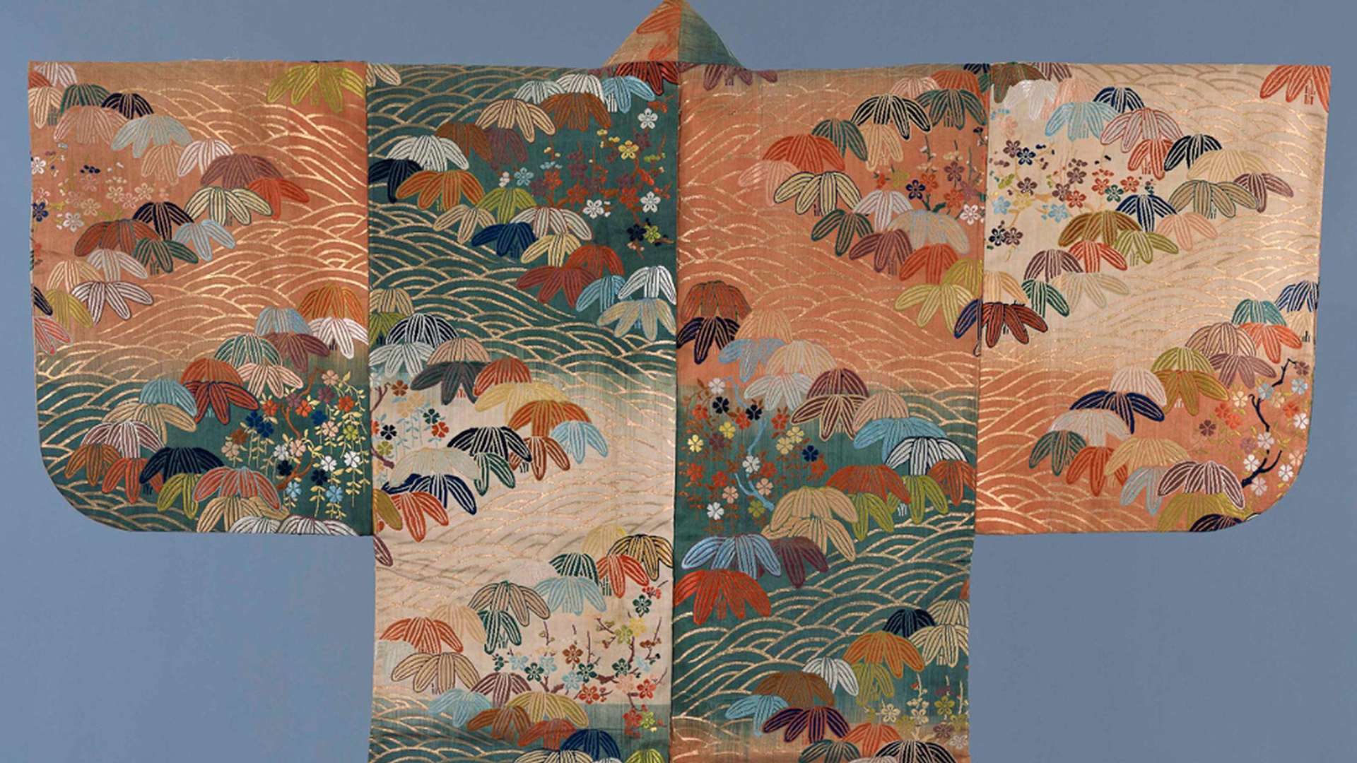 Karaori, Design of abstract wave pattern (seigaiha), Bamboo grass, plum blossoms and cherry blossoms on a ground of alternating blocks of orange-red, white and green, Edo period, 18th century | Courtesy &copy; Sen-Oku Hakukokan Muse